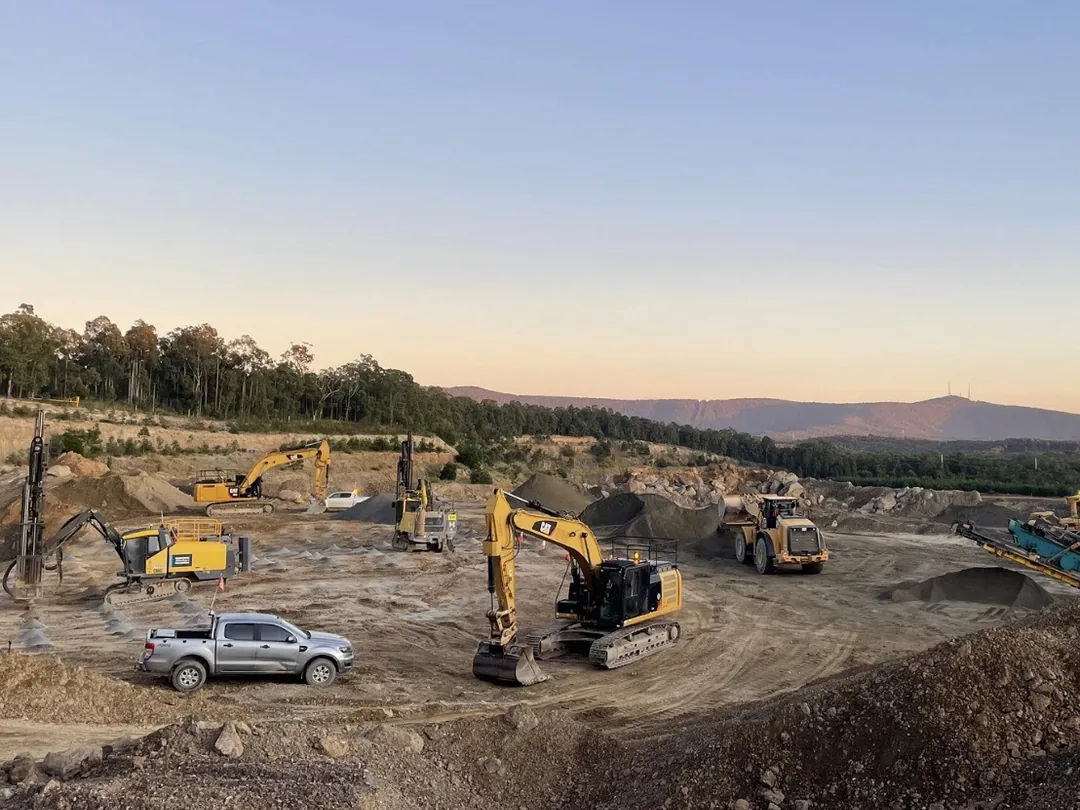 Machines working a large excavation