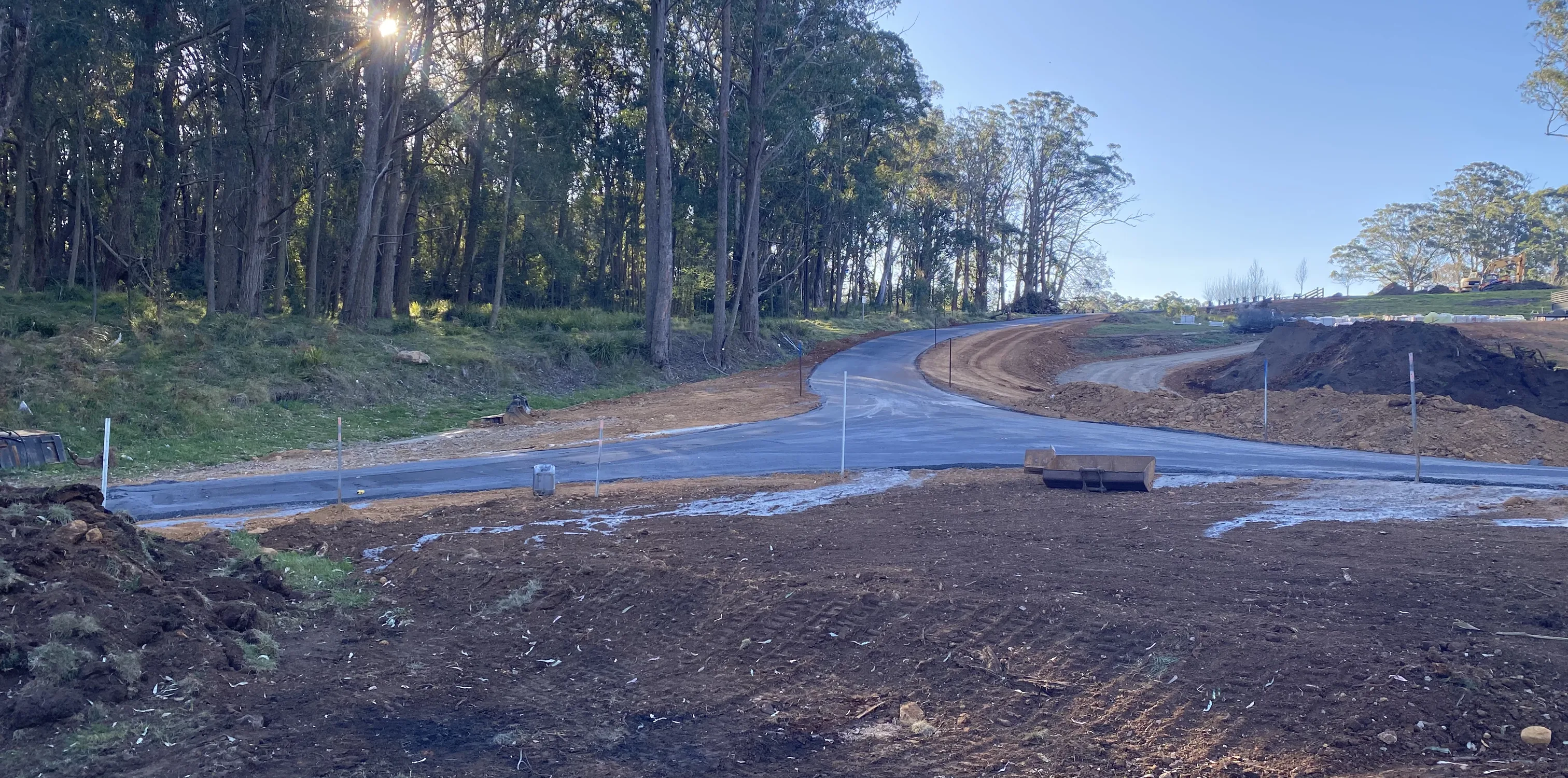 New road construction earthworks running through bush at dusk