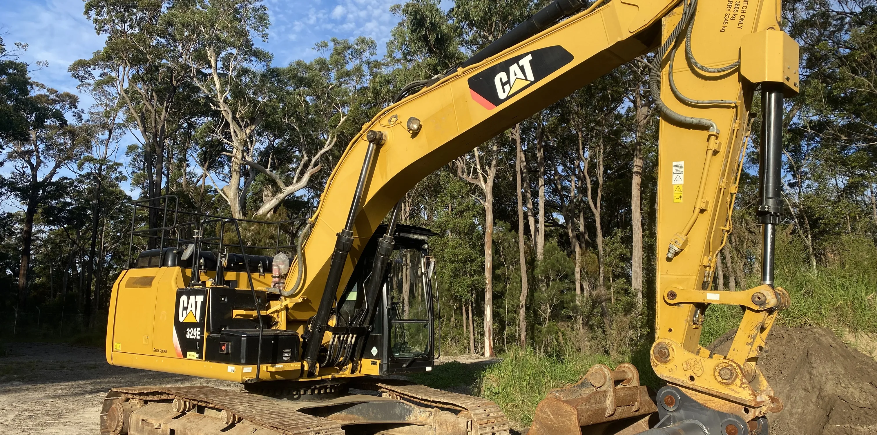 Alliance Excavations CAT excavator on an acreage block under established gums