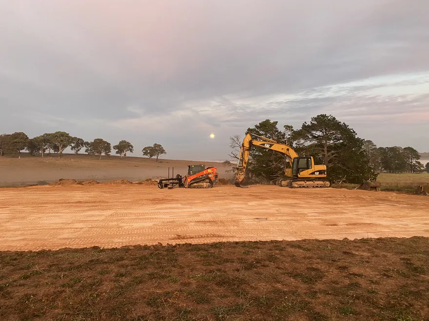 Grading a rural site at dusk