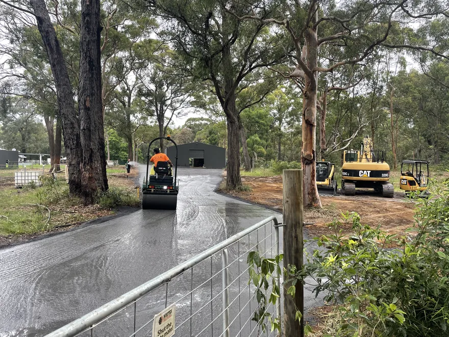 Roller compacting a new driveway